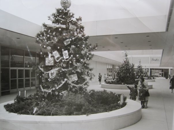Short Hills Mall - pre-enclosure (1962)
A Feature News Service release from 1962 - A Tree full of Christmas Presents is one of six uniquely decorated trees admired by Gretchen and Elizabeth, twin seven-year-olds, and their mother, Mrs. J.P. Zeigler, whil